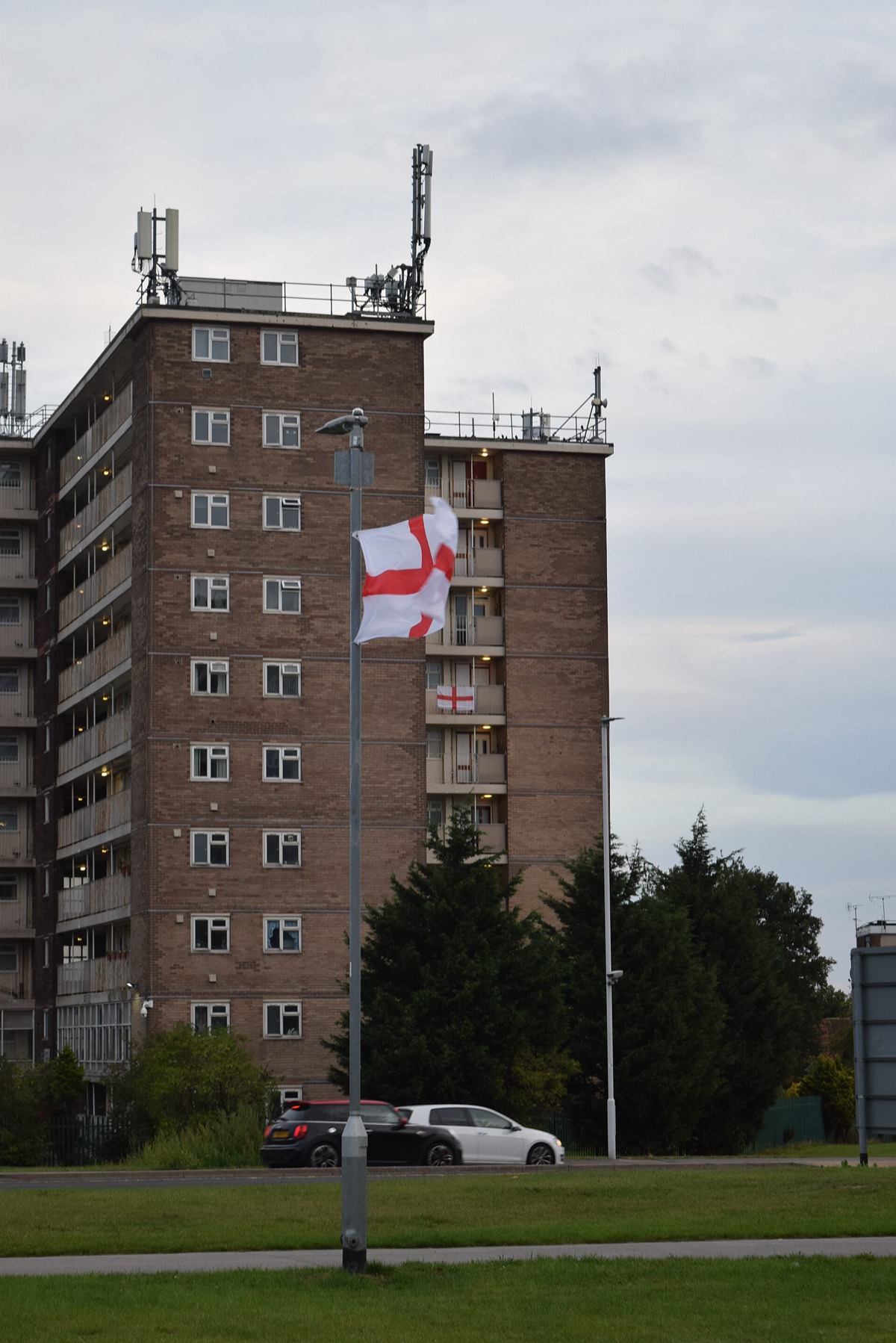 A St George's flag on a lamppost in front of a tower block on York Road, Seacroft, Leeds, in September 2025