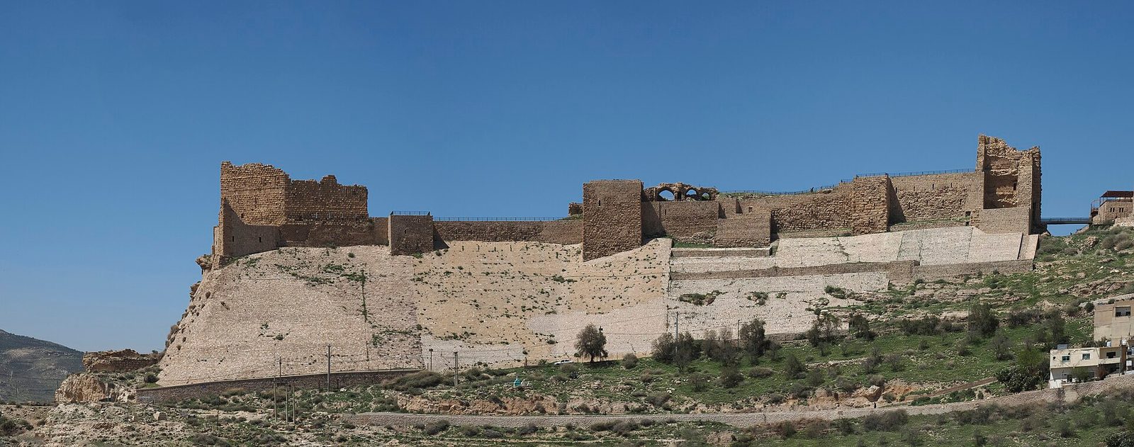 Wide view of a large stone castle on a hillside, Karak
