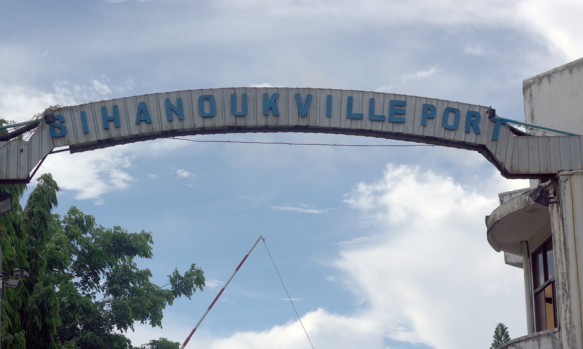 Metal arch reading 'SIHANOUKVILLE PORT' against a cloudy sky, Sihanoukville