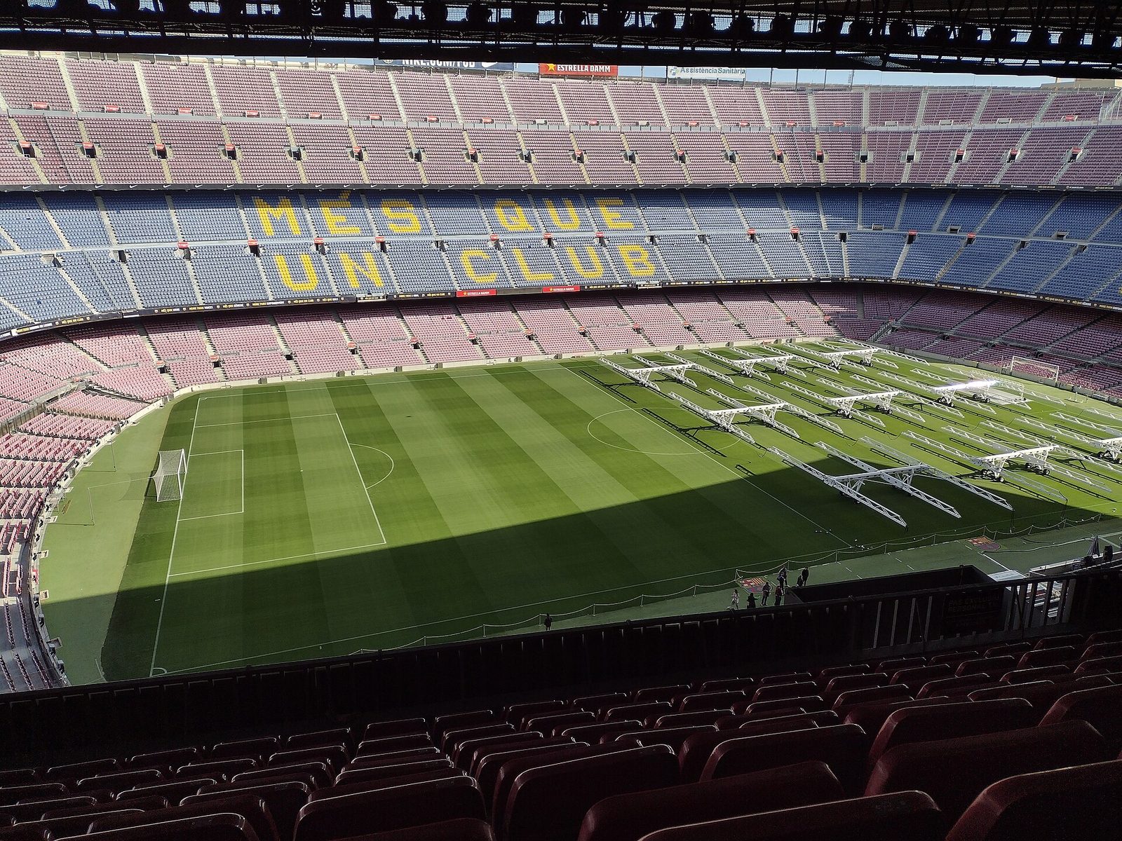 Empty Camp Nou, pitch with maintenance rigs, 'MES QUE UN CLUB' seats, Camp Nou