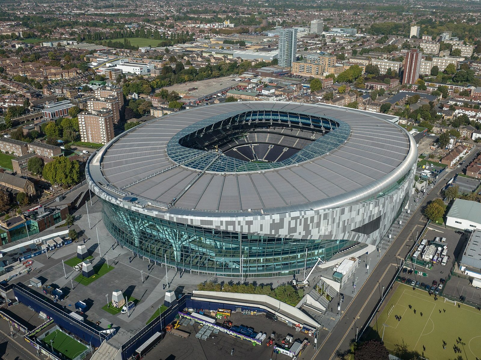 aerial view of a large oval football stadium and surrounding neighbourhood, Tottenham Hotspur Stadium
