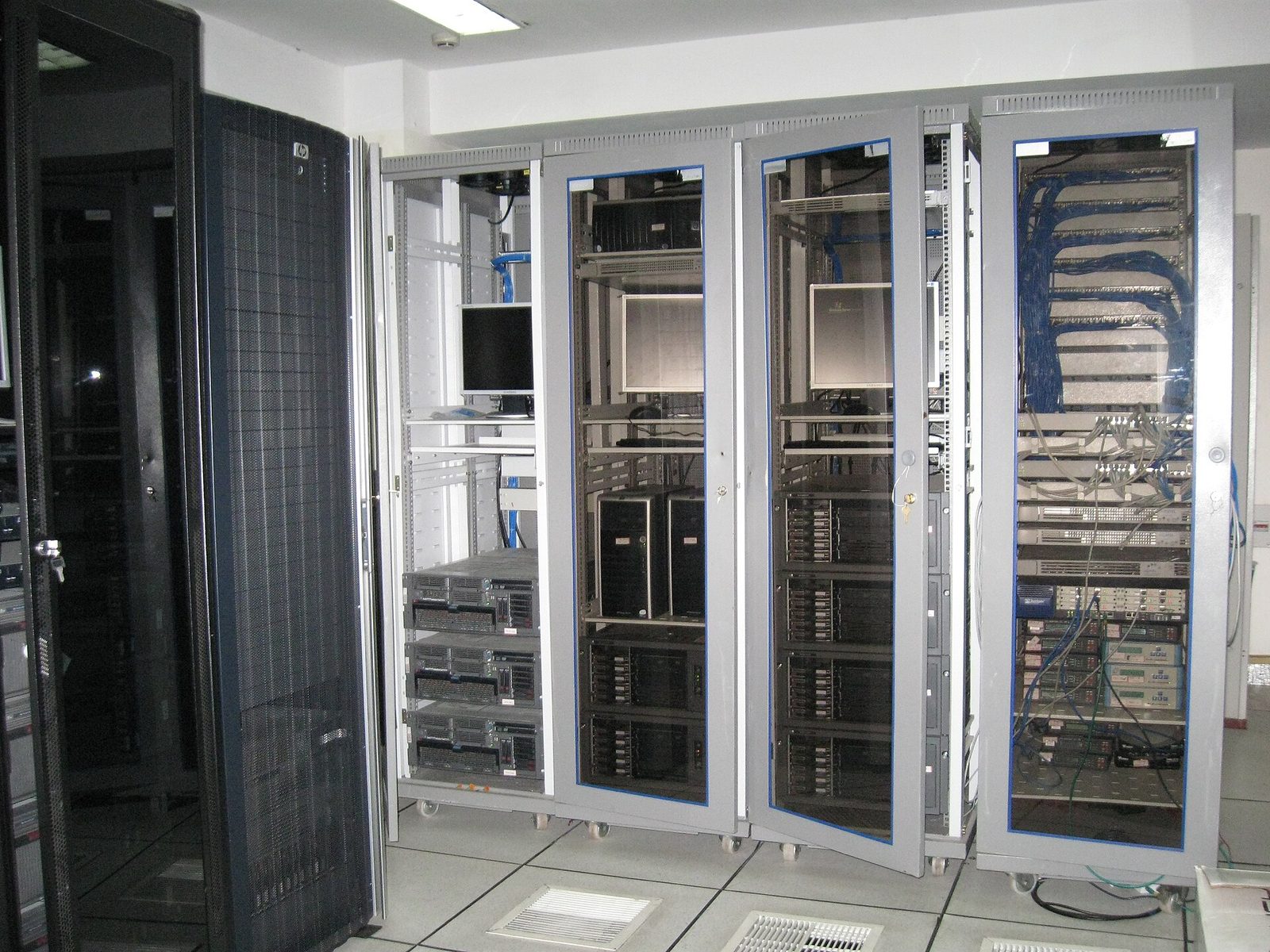Server room racks, network cables and mounted monitors