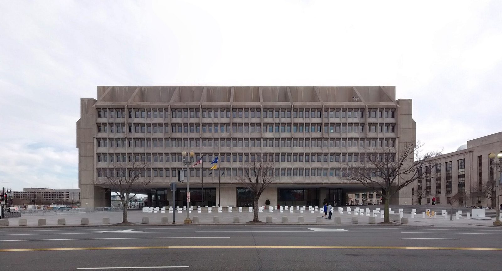 Wide front view of Hubert H. Humphrey Building, plaza and bollards, Washington