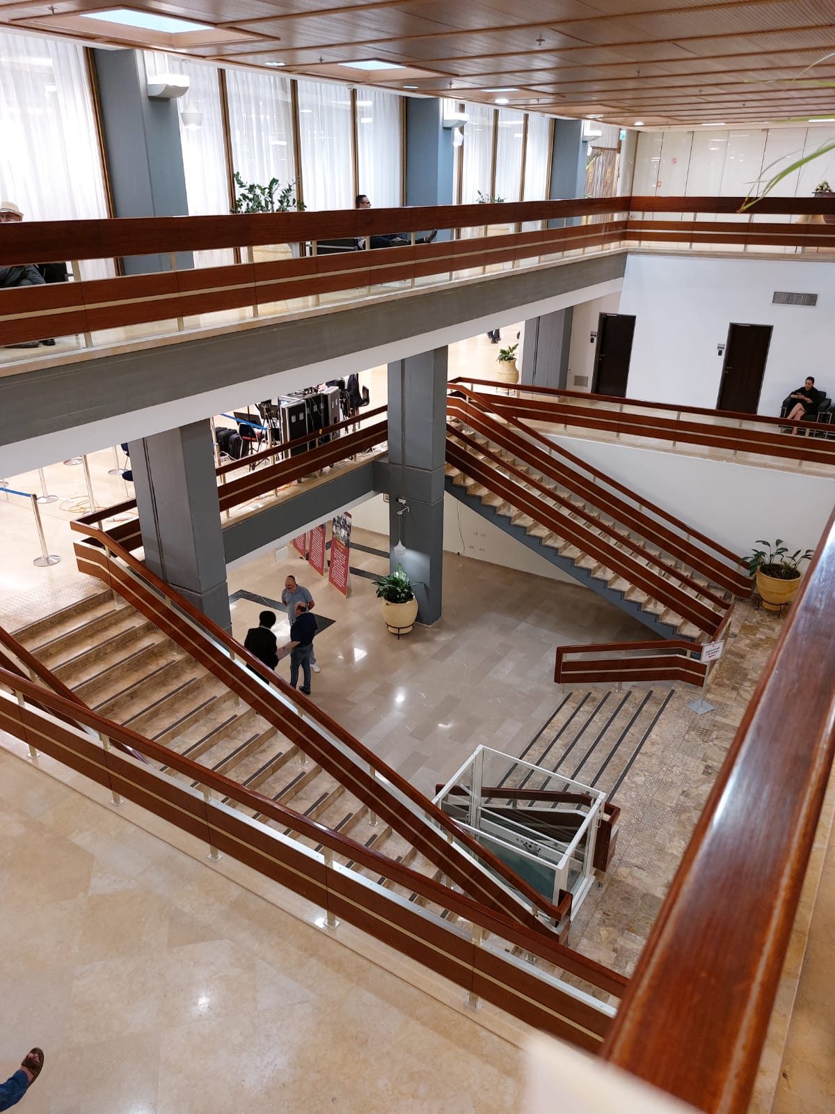 Multi-level interior stairwell and walkways inside a government building