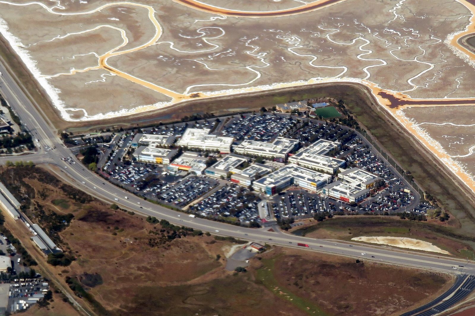 Aerial view of corporate campus, parking lots, and surrounding marshland, California