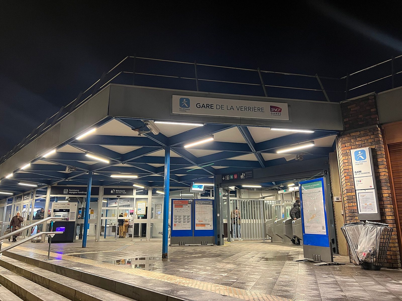 Station entrance Gare de La Verrière lit up at night
