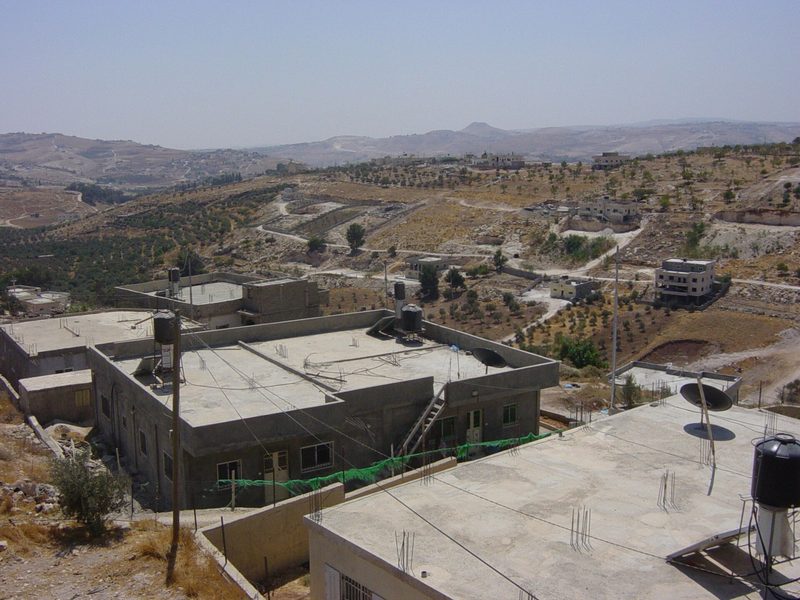 rooftops and hills in a West Bank town landscape