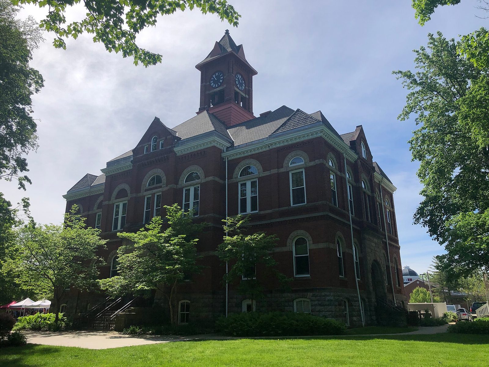 full view of red brick courthouse, clock tower and lawn, Hastings