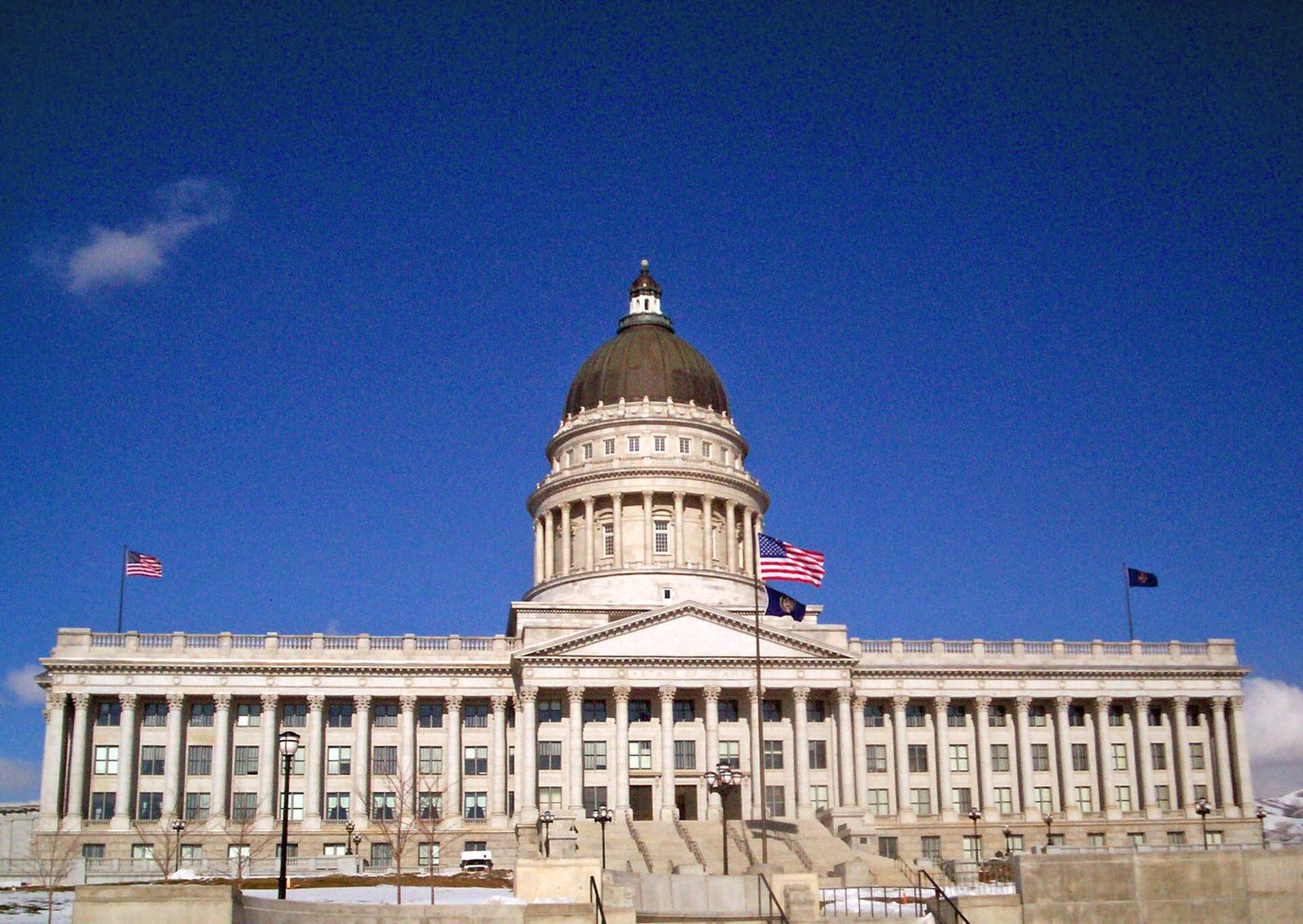 Neoclassical capitol building facade, flags, wide steps, Utah