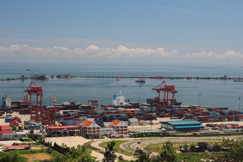 Container yard with cranes, docked ships, sea and distant horizon, Sihanoukville