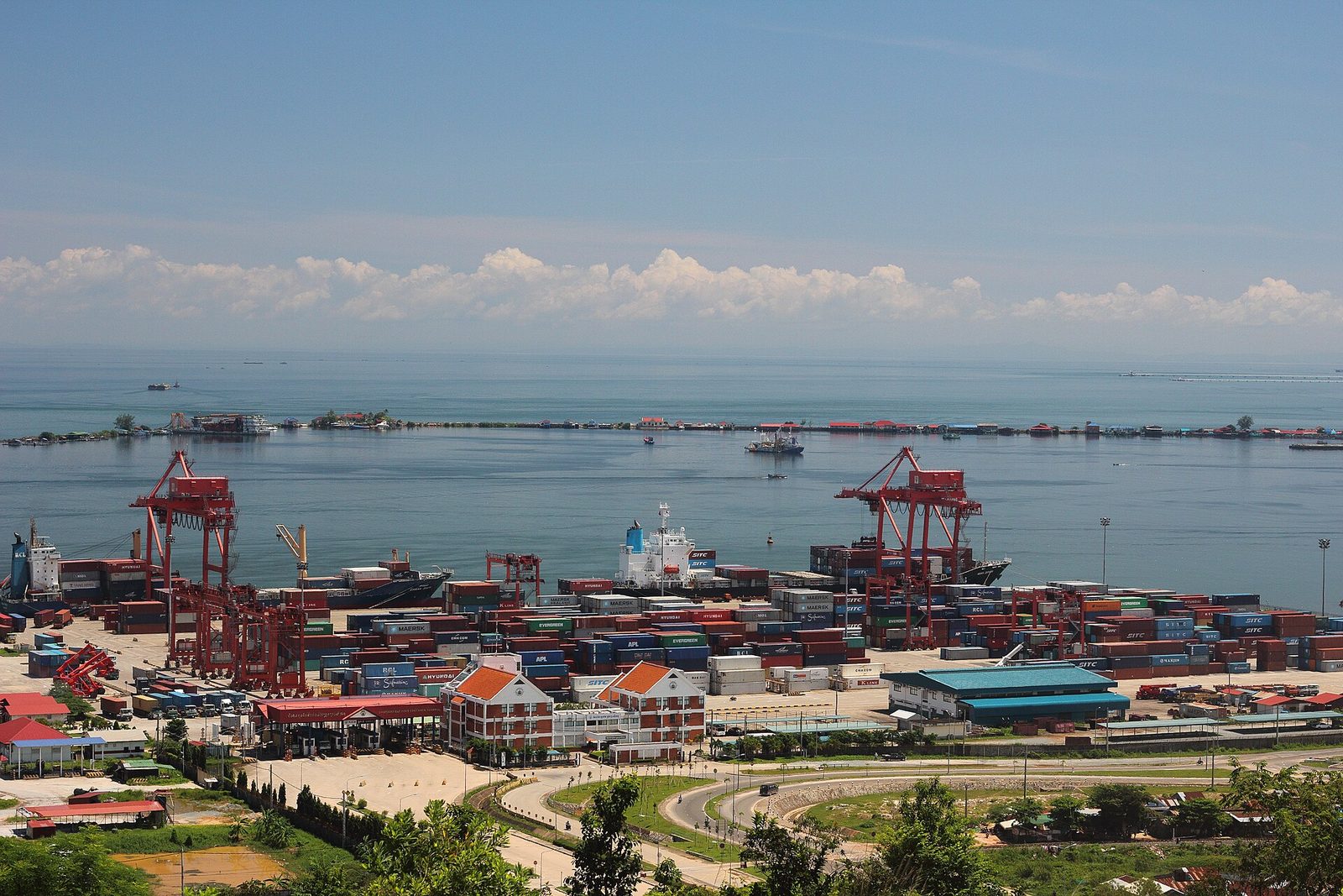 Container yard with cranes, docked ships, sea and distant horizon, Sihanoukville