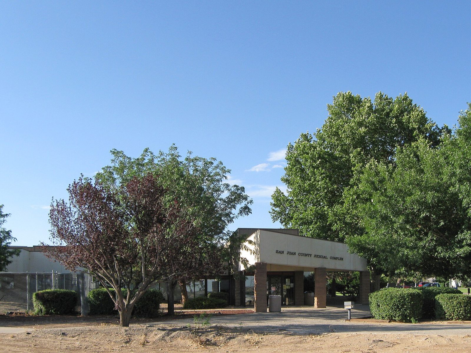 entrance to a low judicial complex, trees and shrubs in front, San Juan County