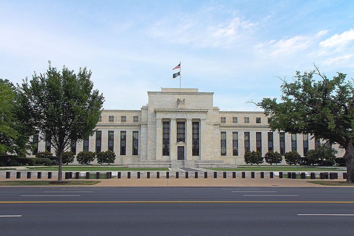 Wide view of a white marble government building, road and trees, Washington