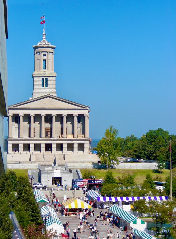 Classical government building with columned portico, tall central tower
