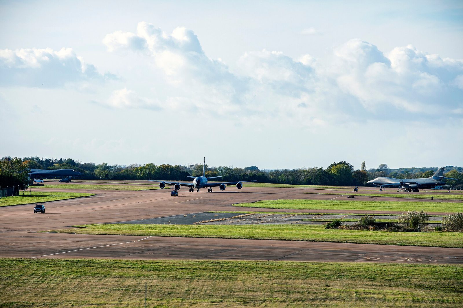 Runway with tanker taxiing, other military aircraft parked on airfield, RAF Fairford