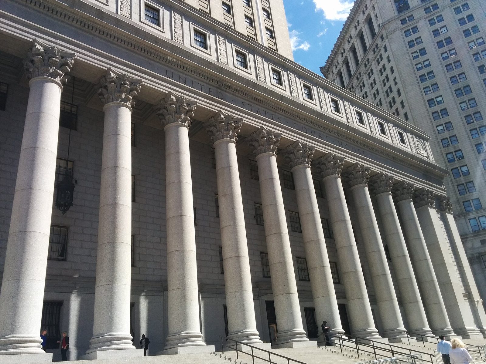 Stone courthouse facade, tall Corinthian columns and steps