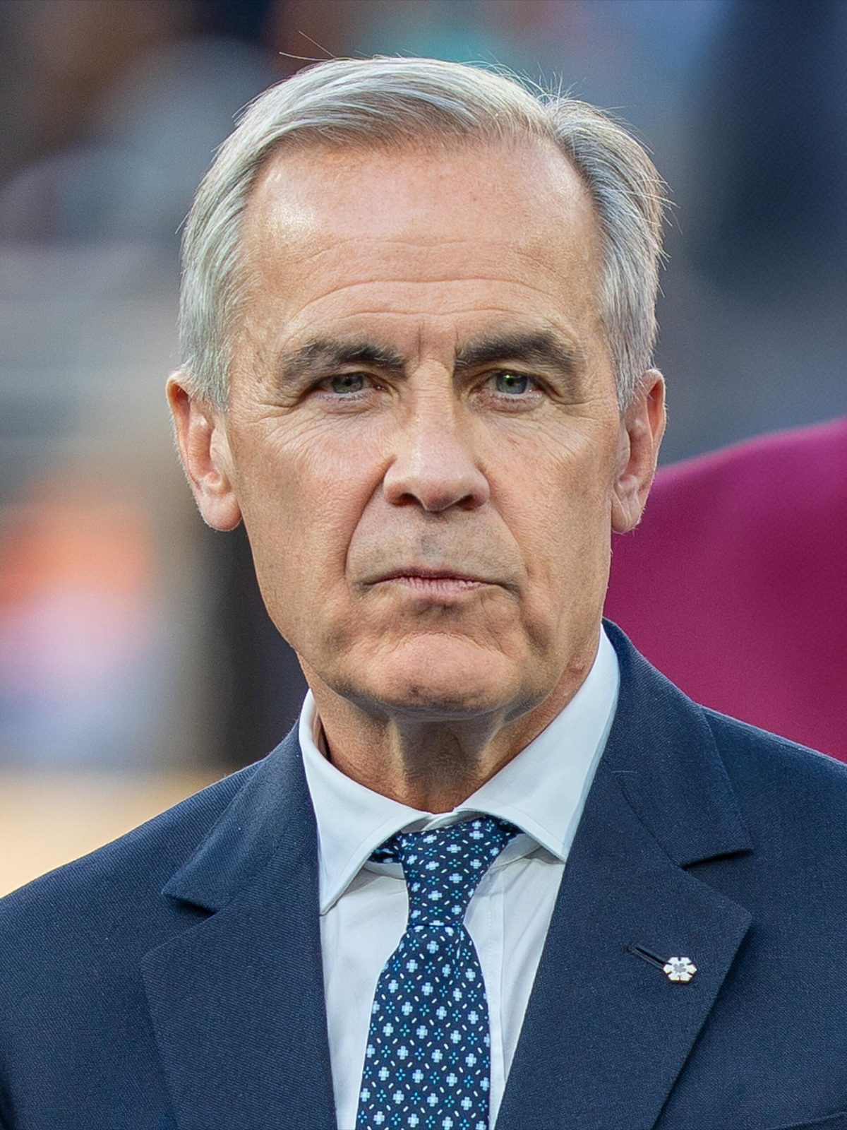 Head-and-shoulders portrait of a middle-aged man in a suit, neutral expression