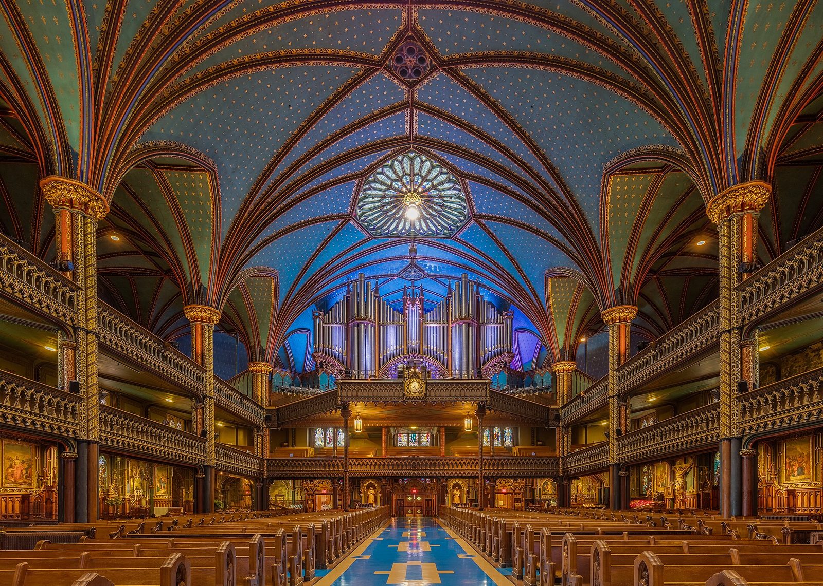 Wide church interior, central aisle, pews and organ loft, Montreal