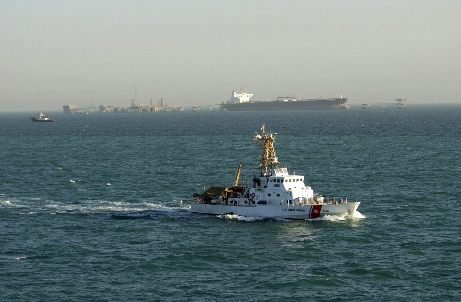 coastguard cutter patrolling waters, oil terminal and tanker beyond, Persian Gulf