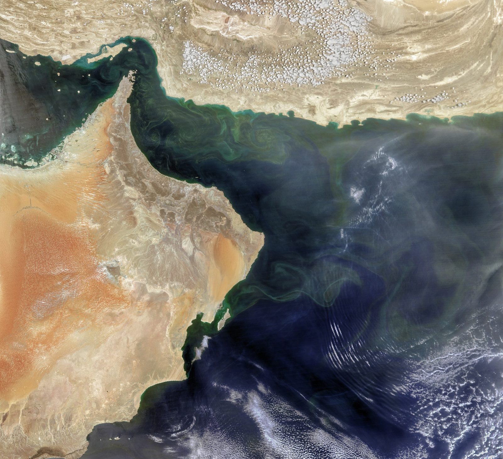 Satellite view of Arabian peninsula coast and surrounding waters, visible sea swirls.