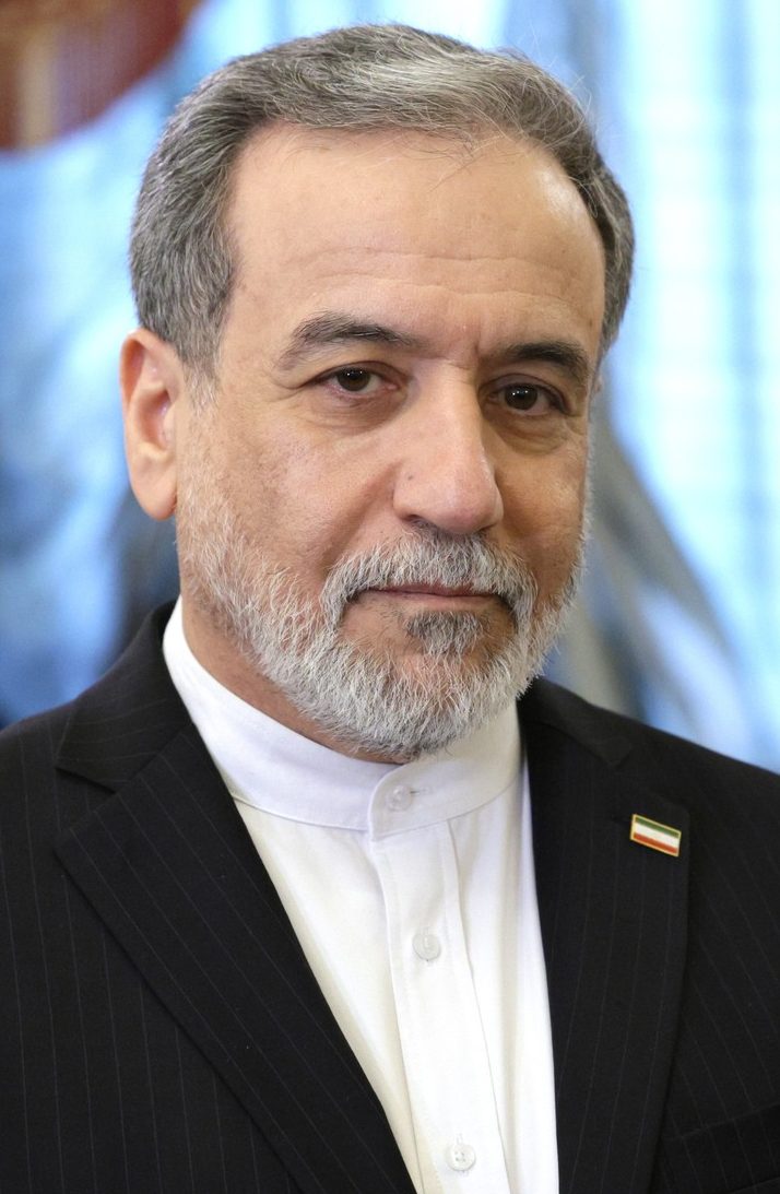 close-up headshot of a bearded man in a suit