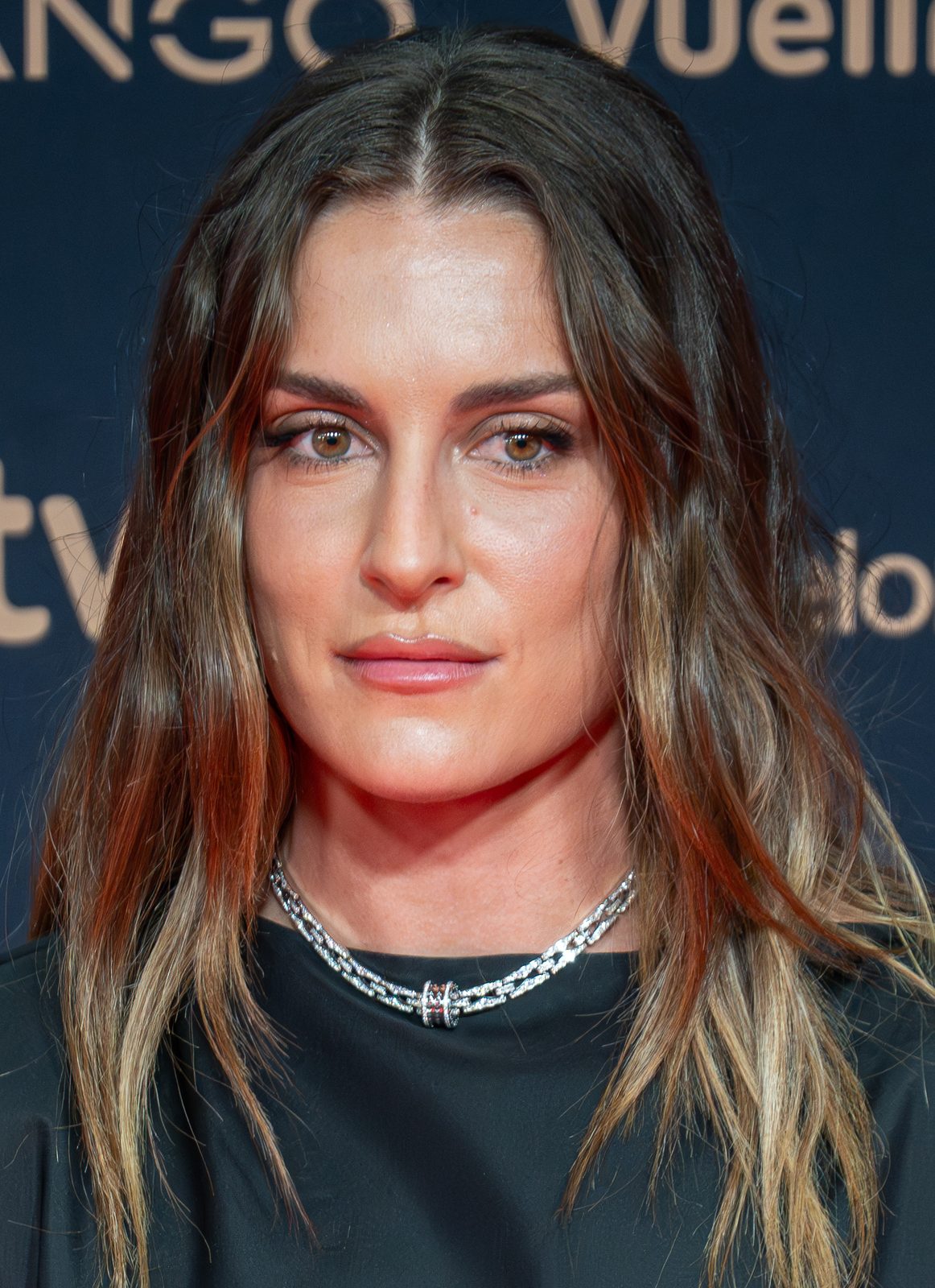 close-up portrait of a woman on a red-carpet backdrop