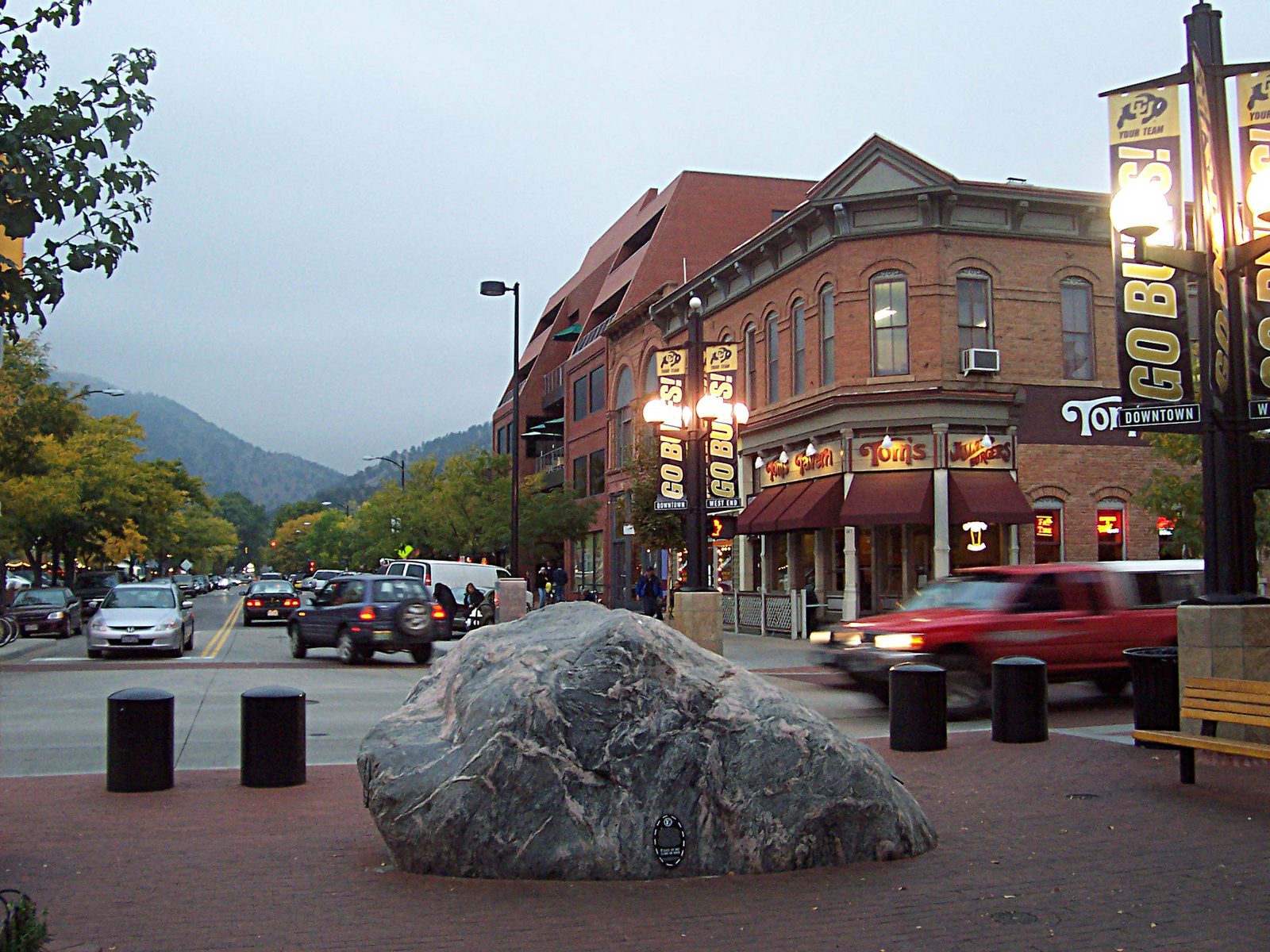Wide view of Pearl Street Mall, large rock in foreground, shops and, Pearl Street Mall