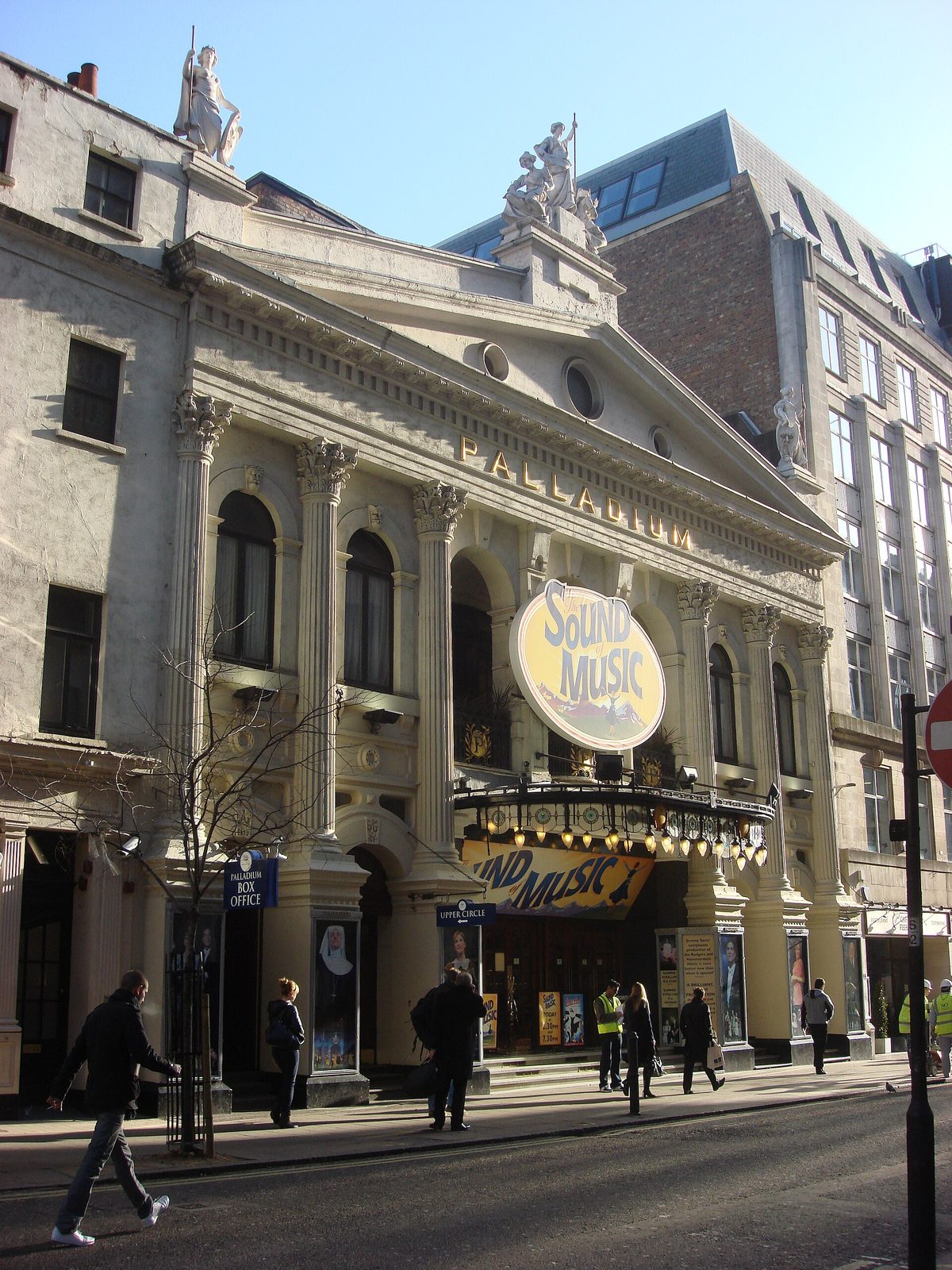 Front façade of the London Palladium, marquee and pedestrians outside, London Palladium
