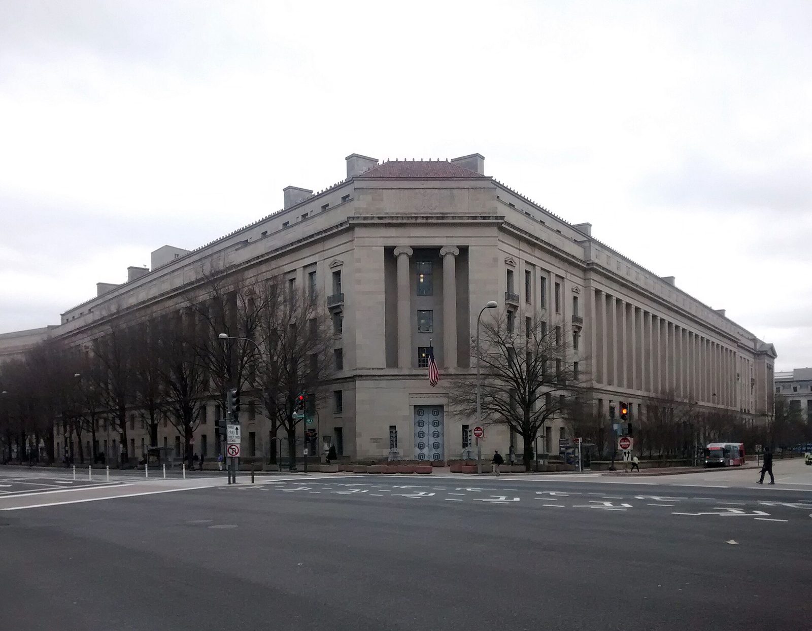 corner view of a large stone government building on a city street