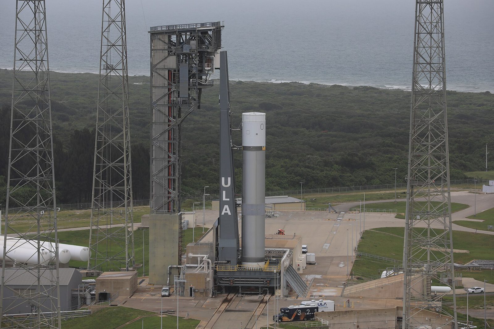 Vulcan test article vertical at launch pad, gantry and coastal backdrop, Cape Canaveral Space Launch Complex 41