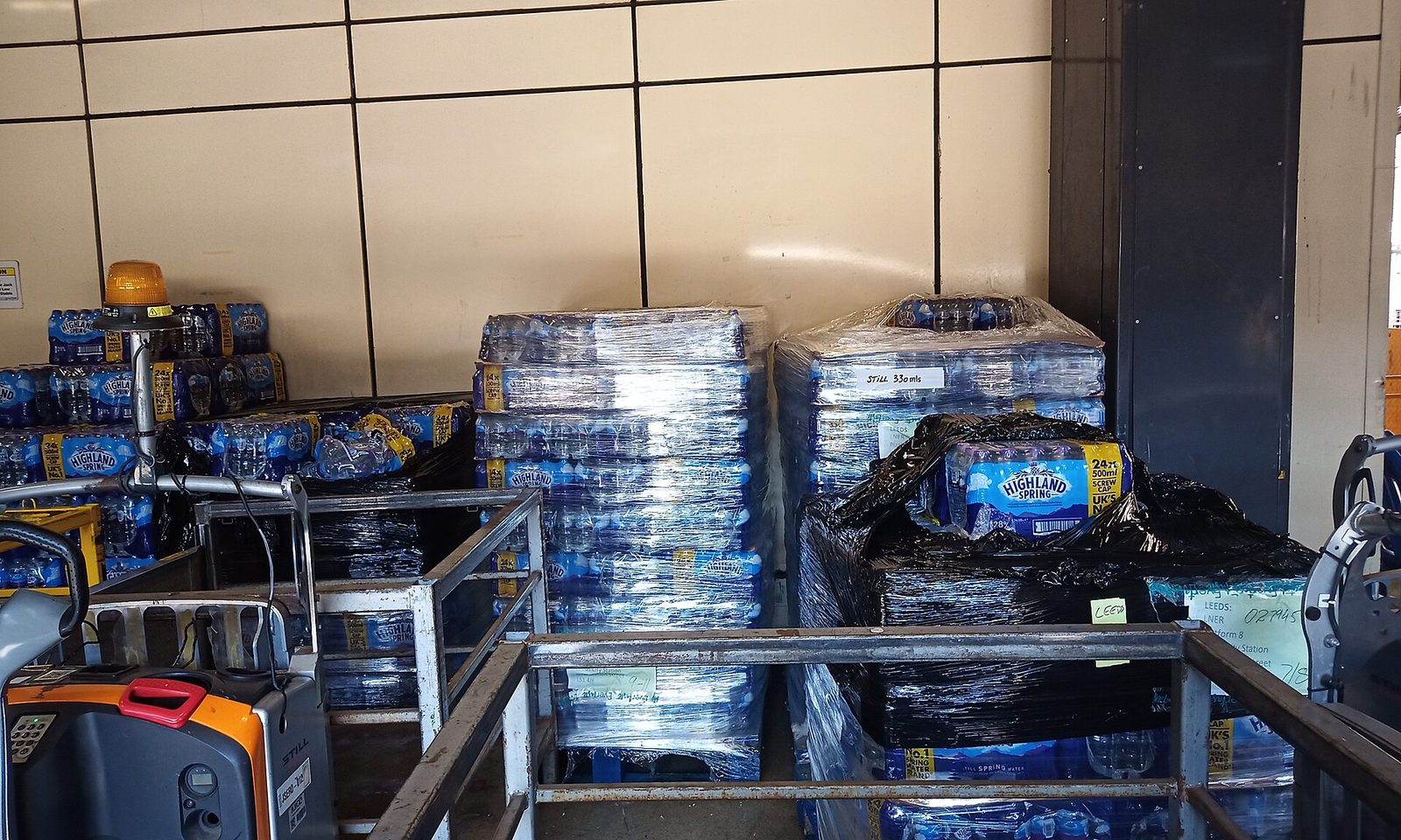 Pallets of shrink-wrapped bottled water inside station