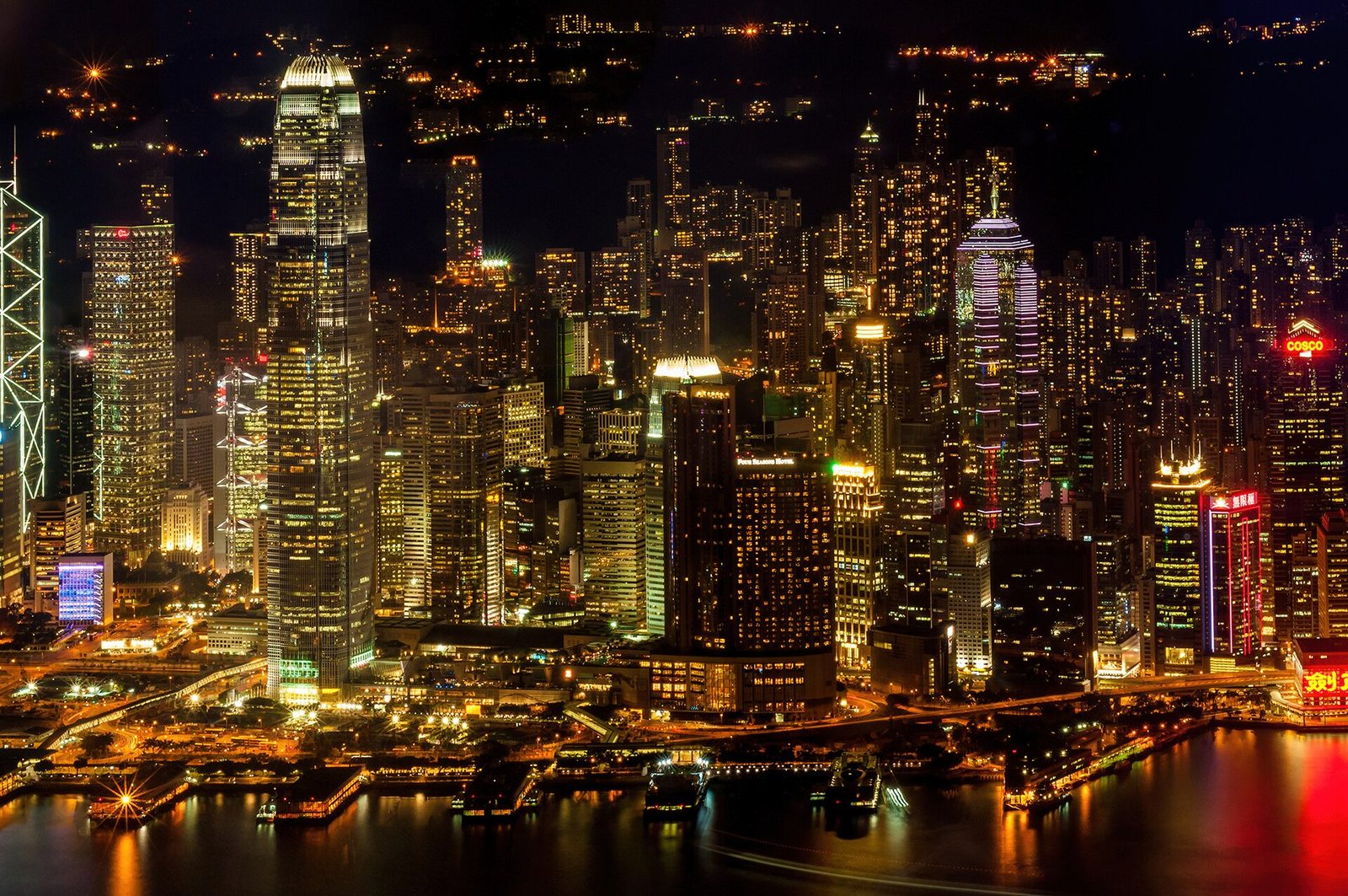 Night view of Victoria Harbour, densely lit skyscrapers and reflections, Hong Kong