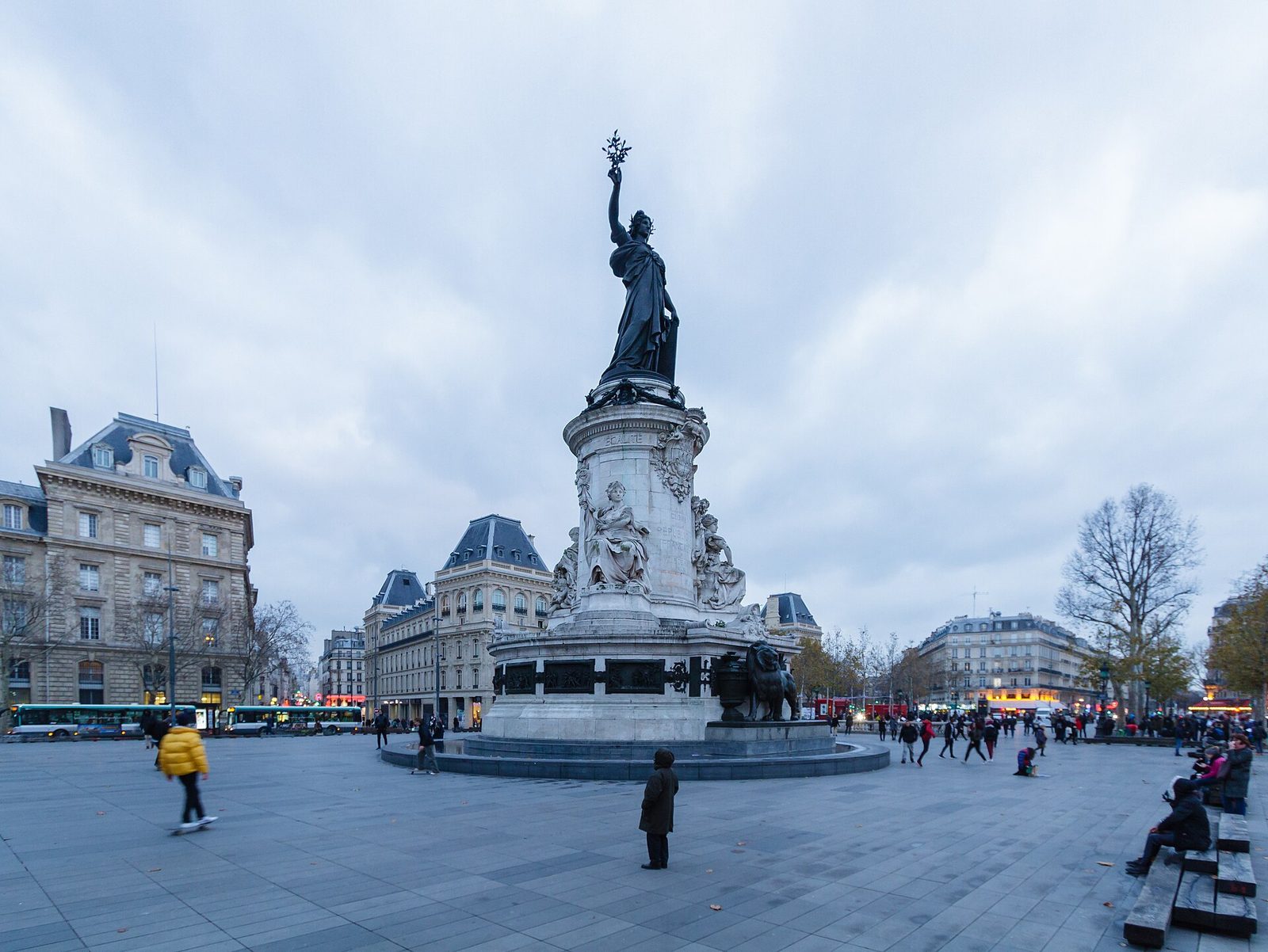 Large open square with central monument, people scattered around