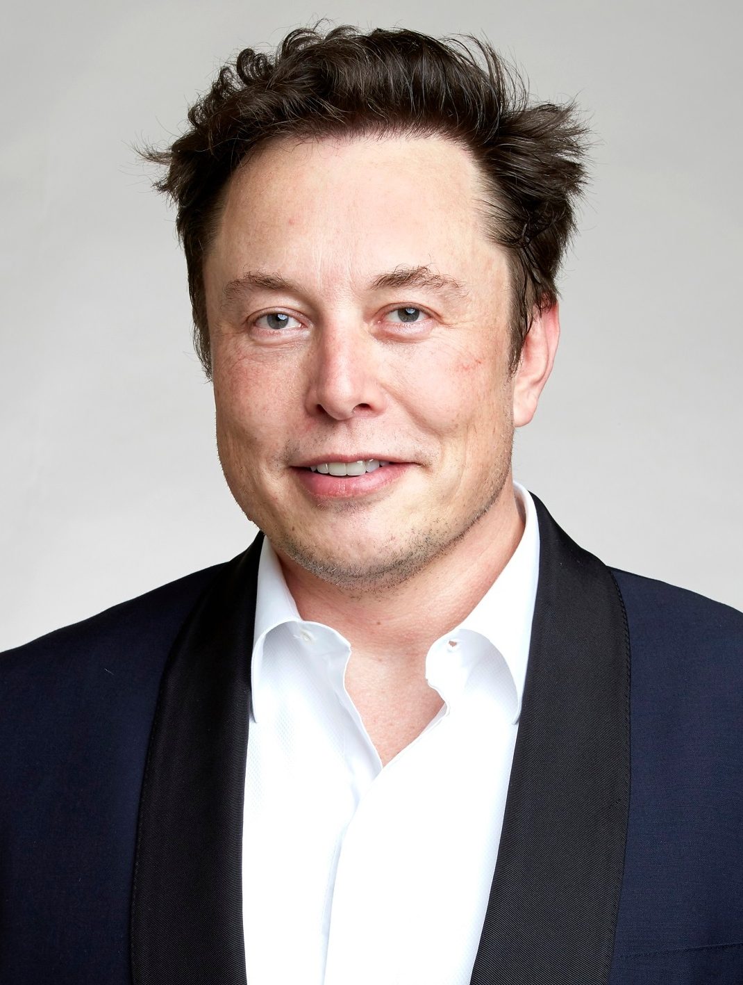 Cropped head-and-shoulders portrait of a man in a white shirt