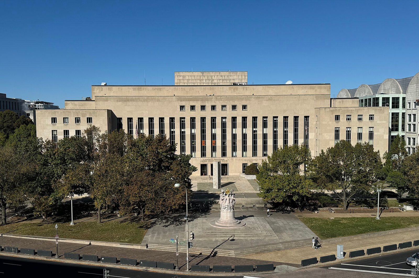 Elevated frontal view of courthouse with plaza and statue, Washington
