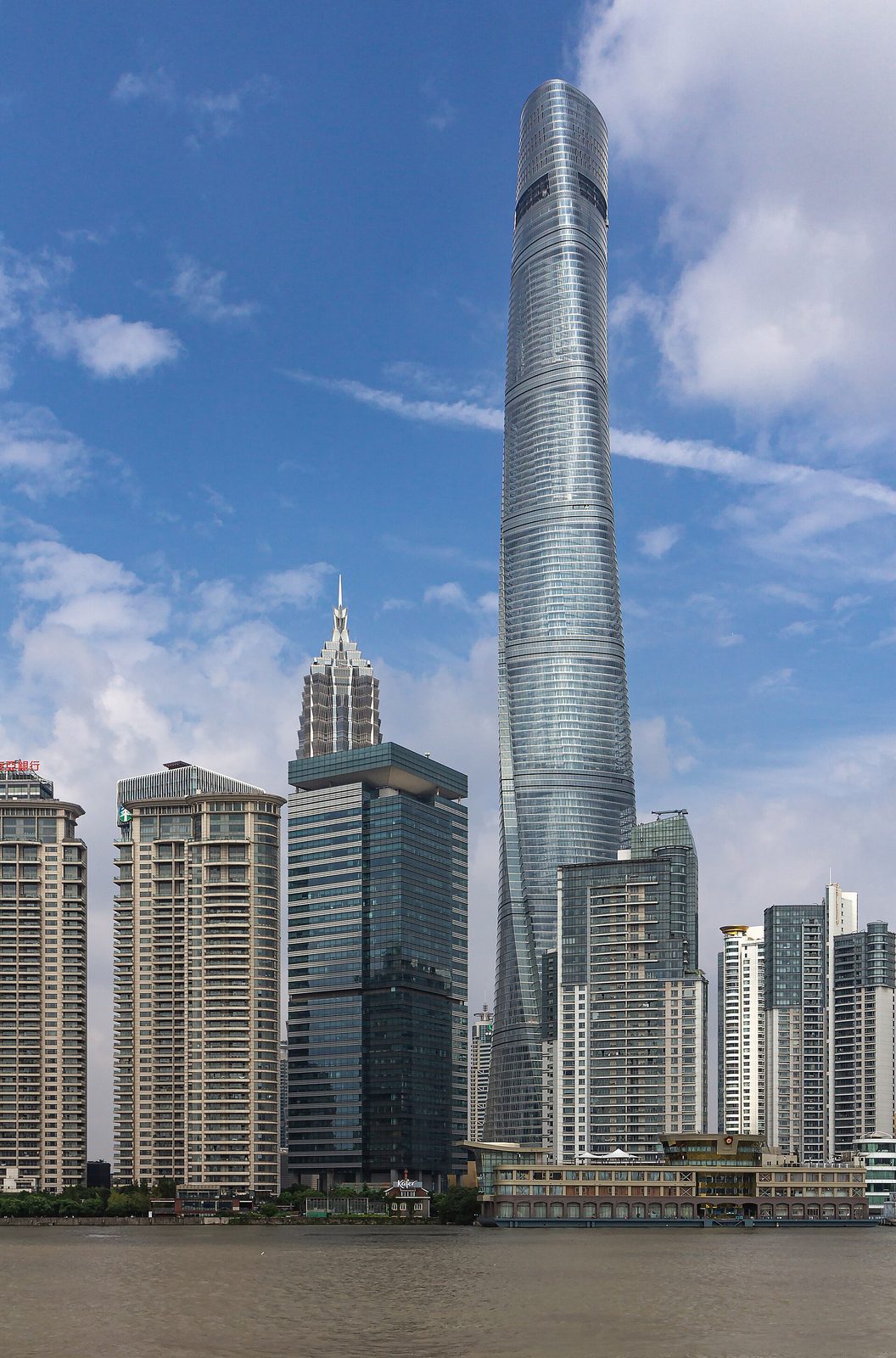 Tall cylindrical tower, riverside high-rises and pedestrian walkway, China