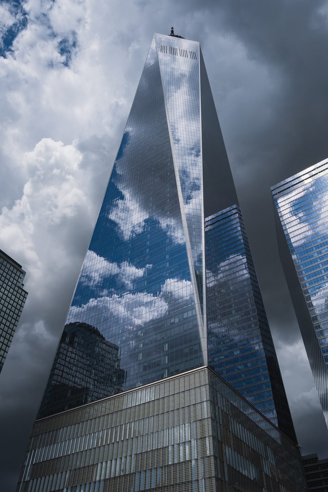 Worm's-eye view of One World Trade Center reflecting clouds., New York City