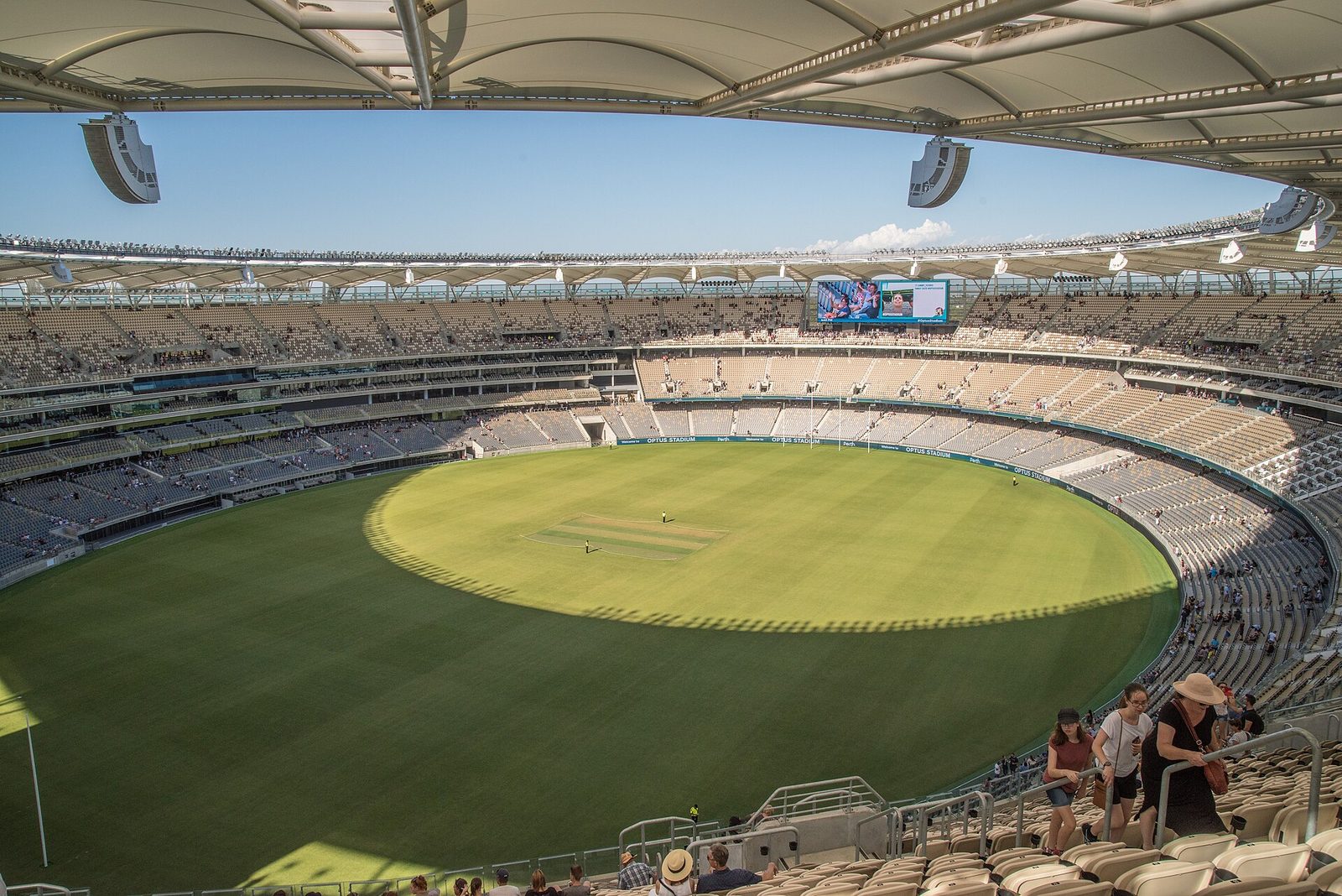 Wide interior view of largely empty oval stadium bowl and pitch, Perth