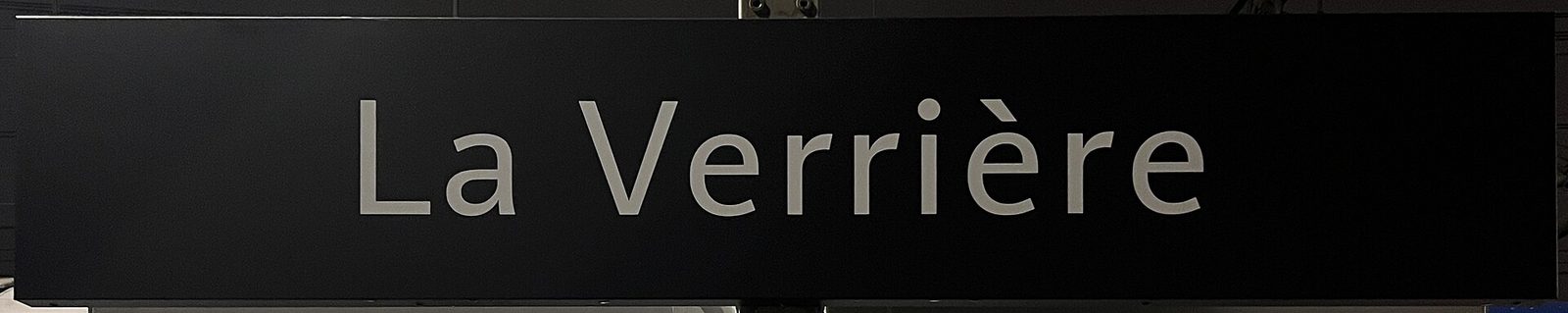 Station information panel 'GARE DE LA VERRIÈRE' mounted on brick