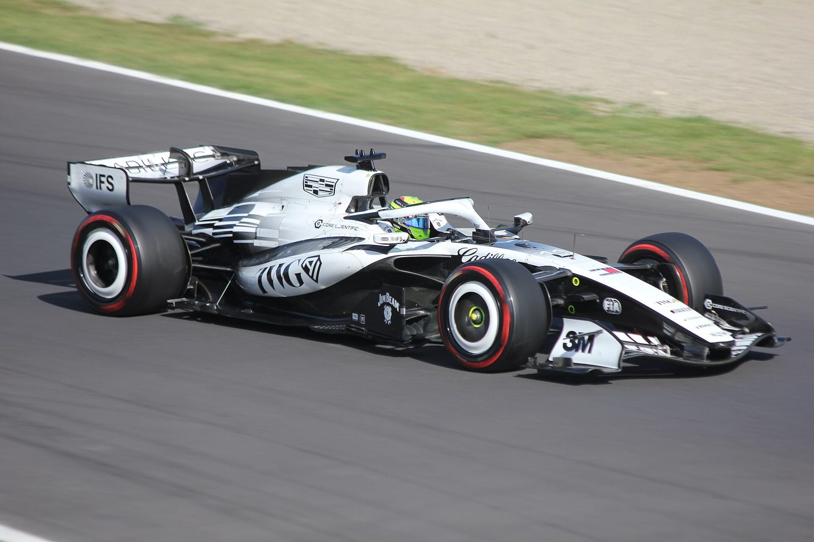 Cadillac Formula 1 car on track, driver visible in cockpit and helmet