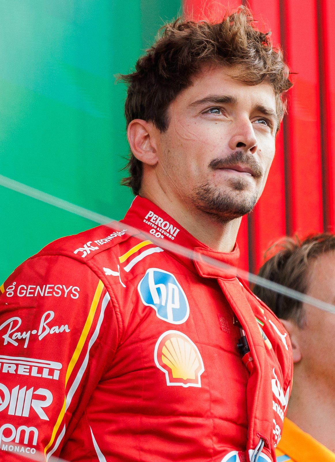 Close portrait of a man in a red Ferrari race suit on
