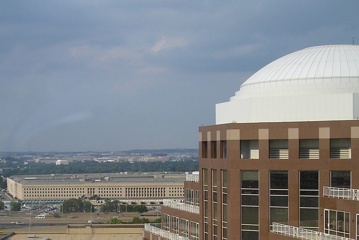 distant low government office building seen past a brown domed block