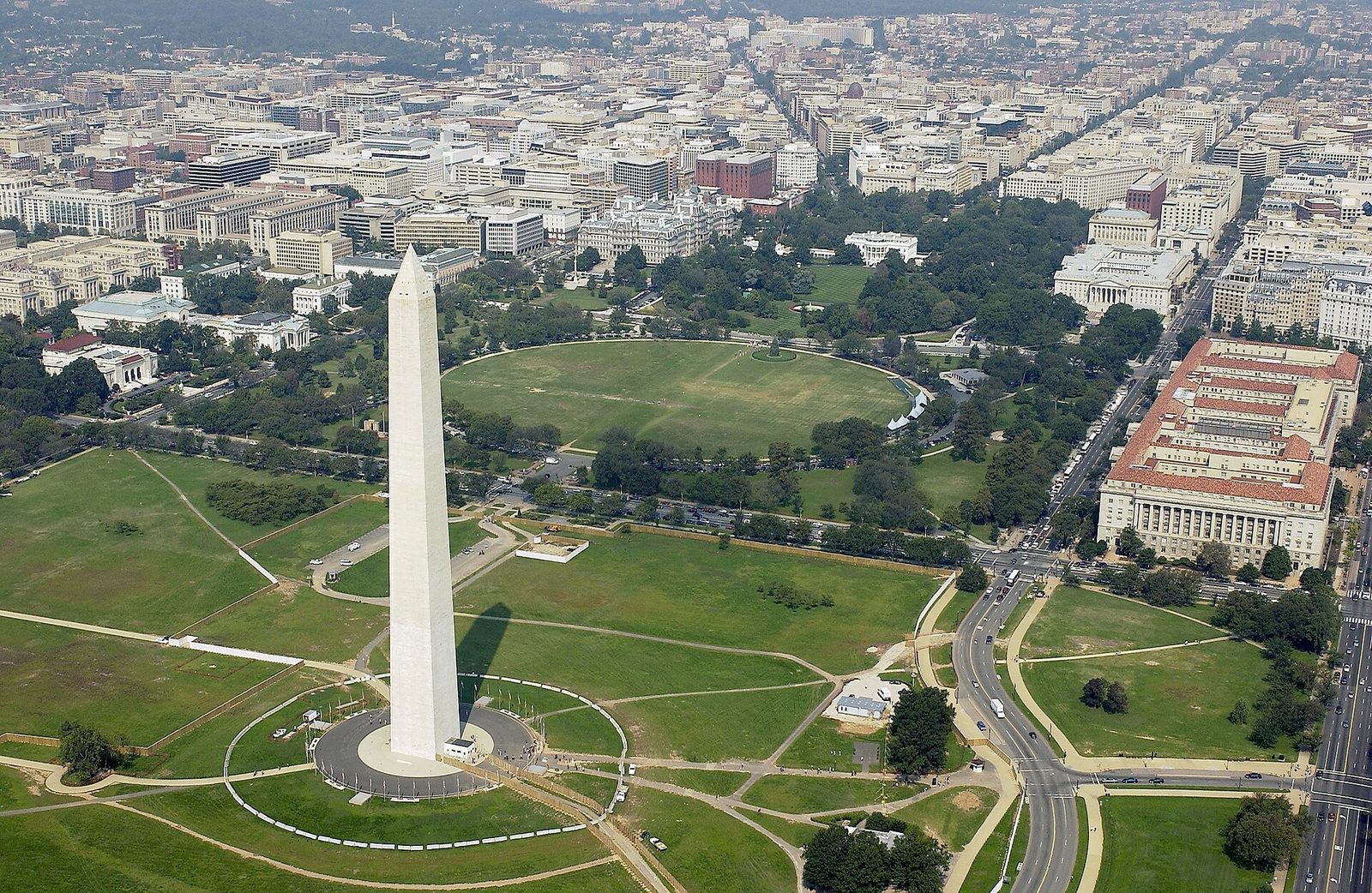 Aerial view of an obelisk monument and a nearby executive mansion in, Washington
