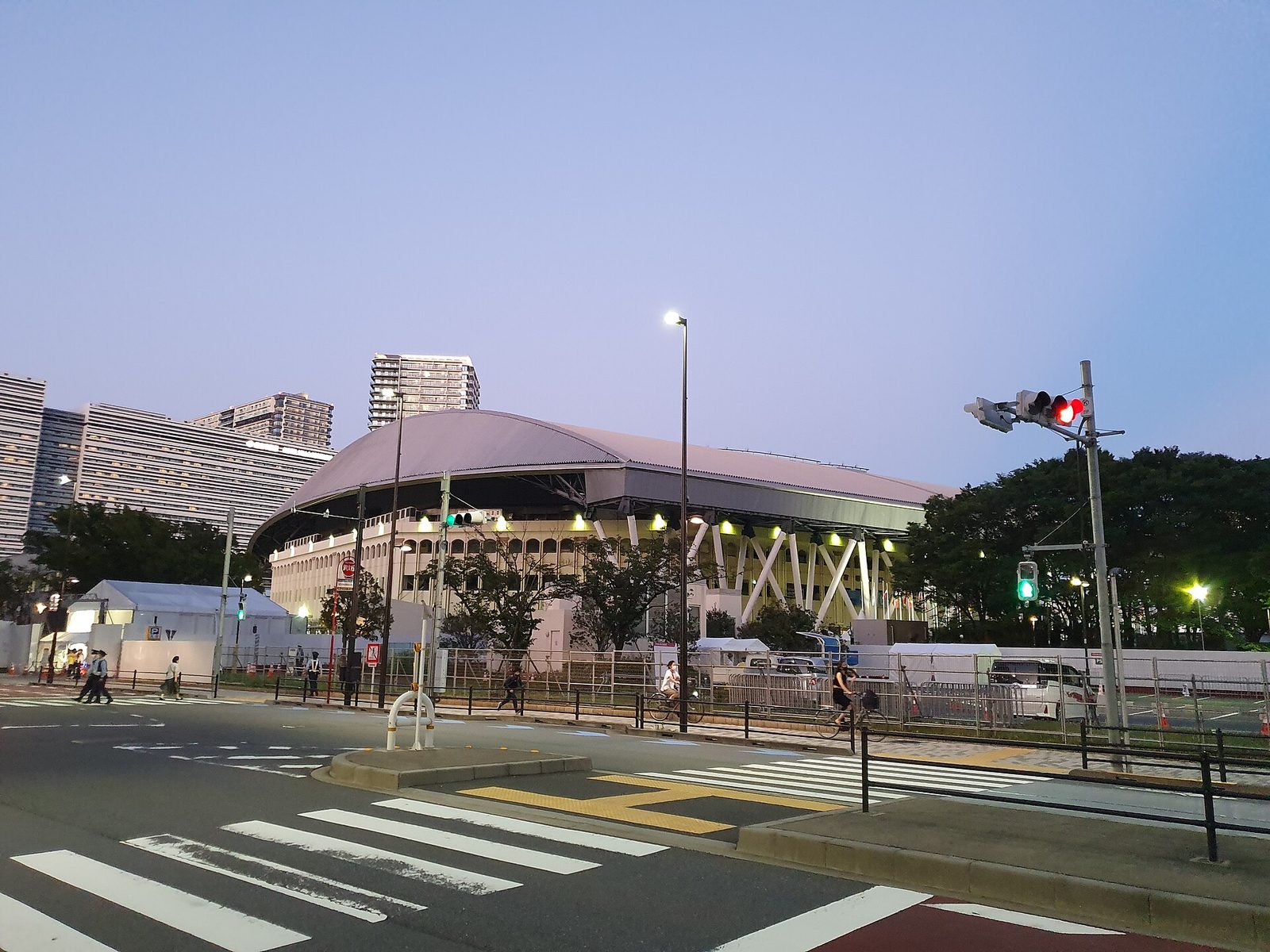 Domed sports arena beside a street, pedestrian crossing visible, Ariake Coliseum