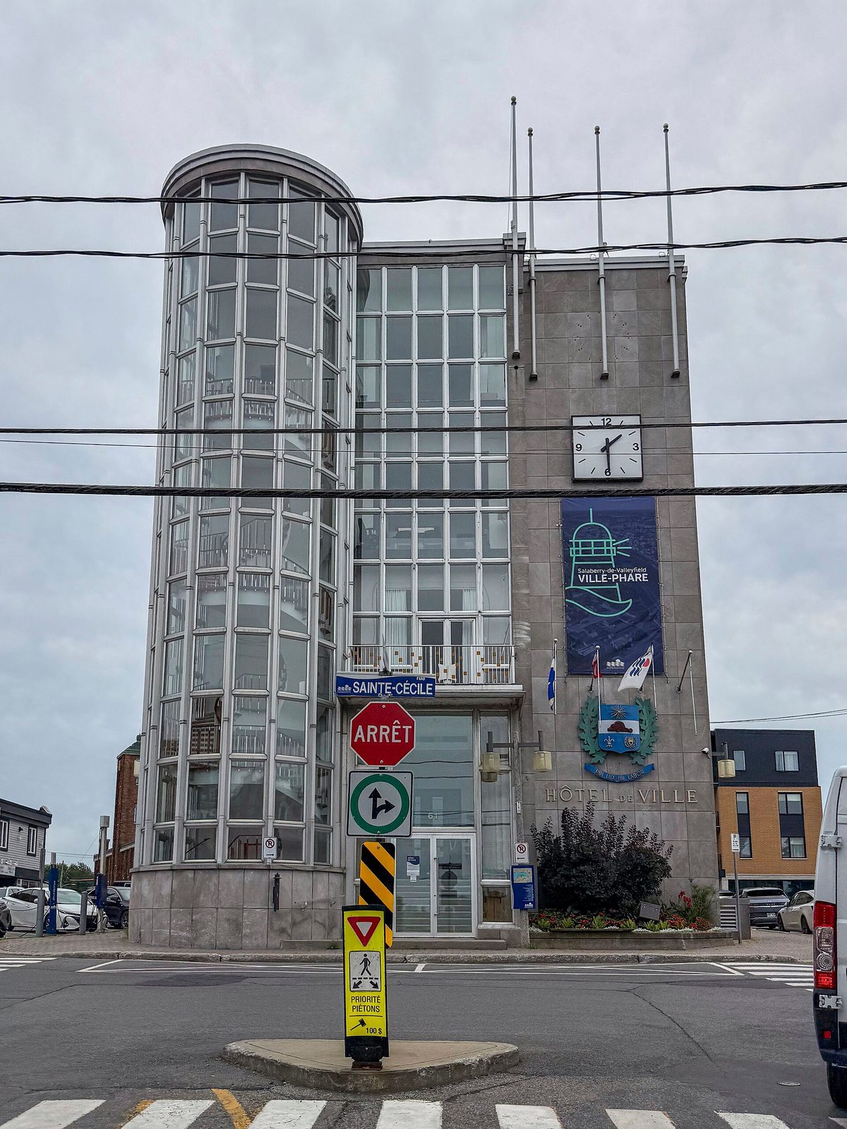 City Hall façade, road signs and flags in foreground