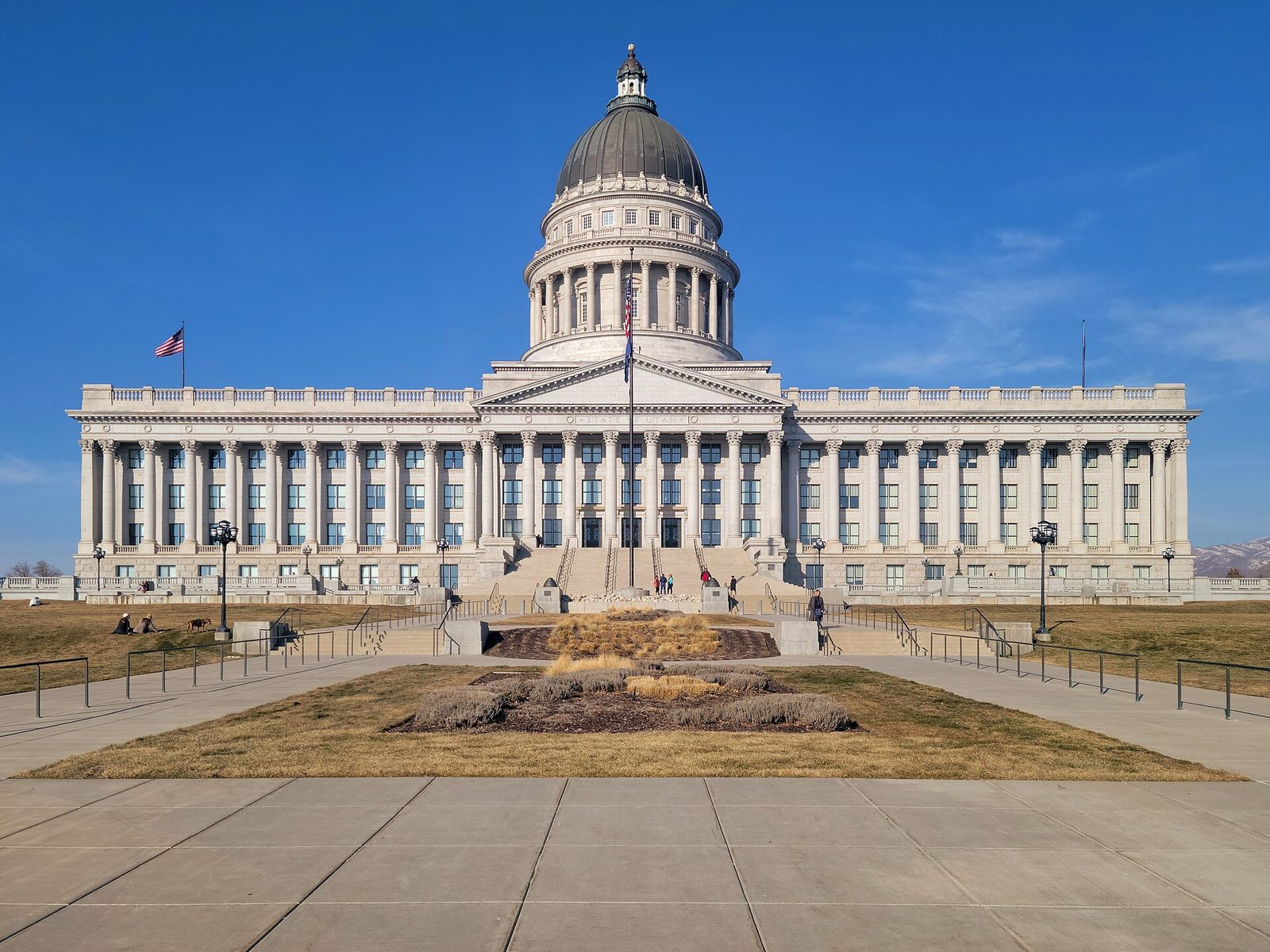 Front façade of grand capitol building, steps and flagpoles, Utah