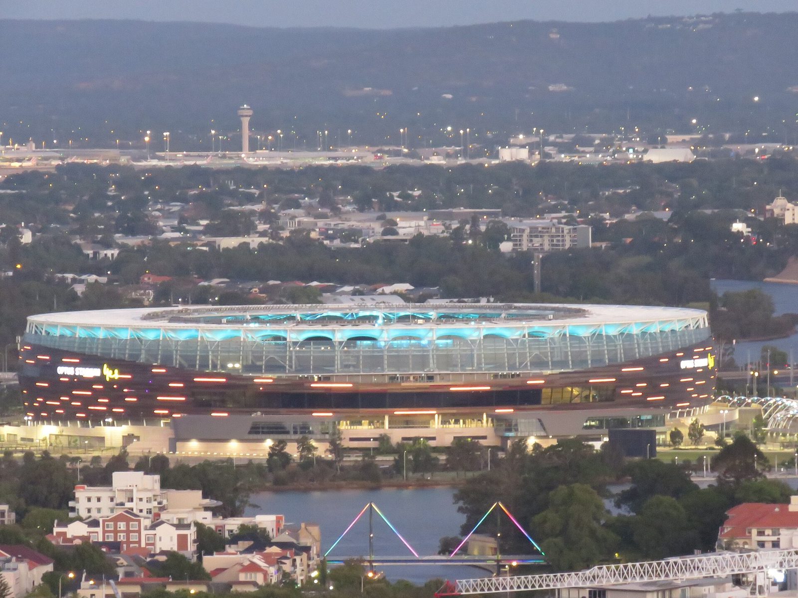 Aerial view of the illuminated stadium at dusk from distance, Perth
