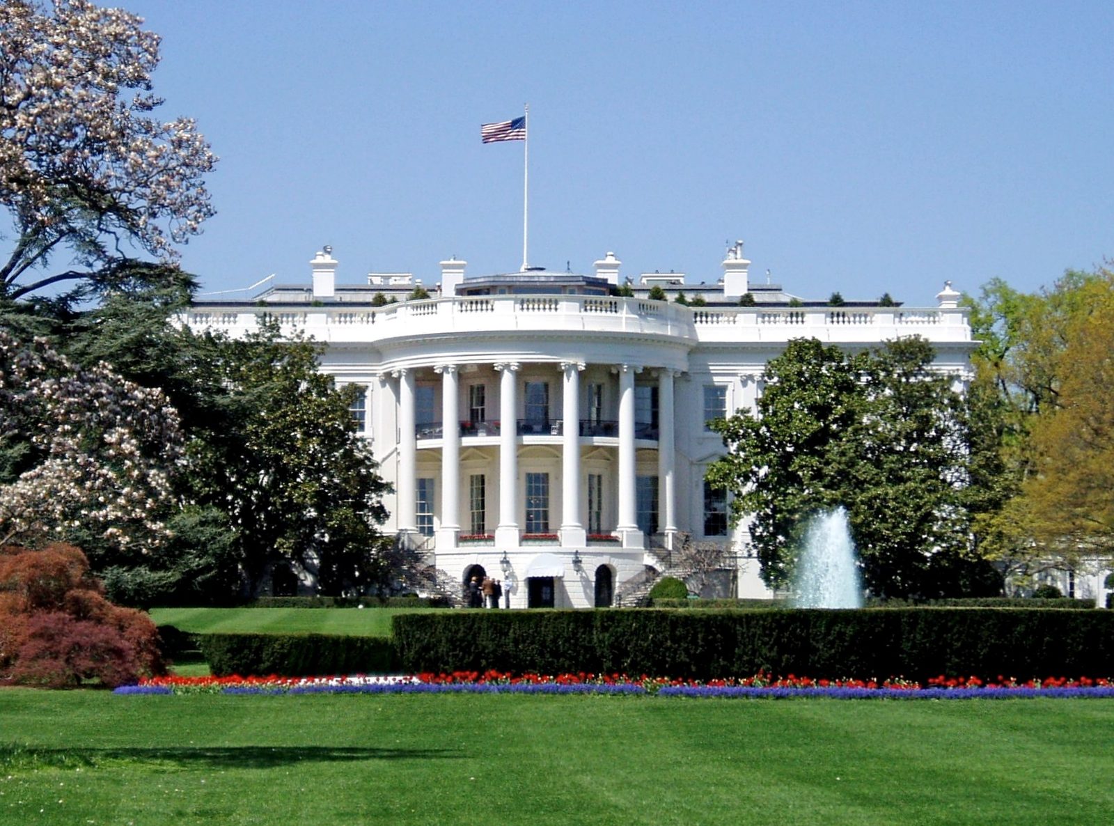 Neoclassical executive mansion with US flag, fountain and lawn, Washington