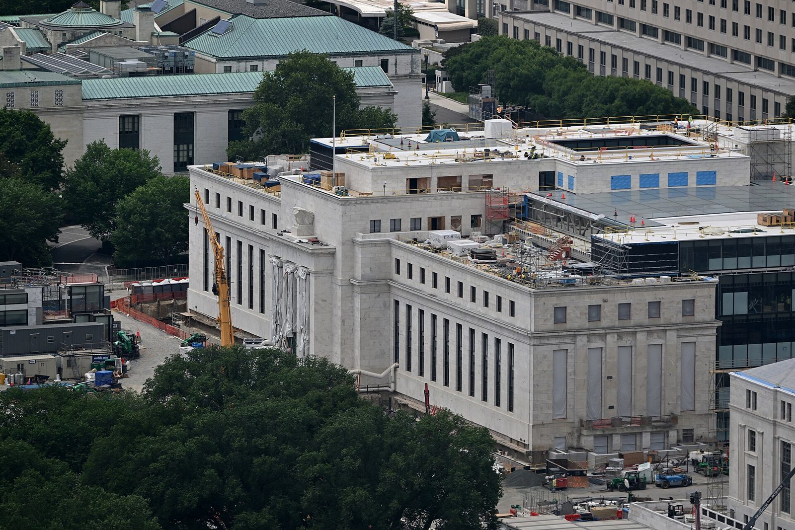 Aerial view of a marble building undergoing renovation, cranes and equipment, Washington