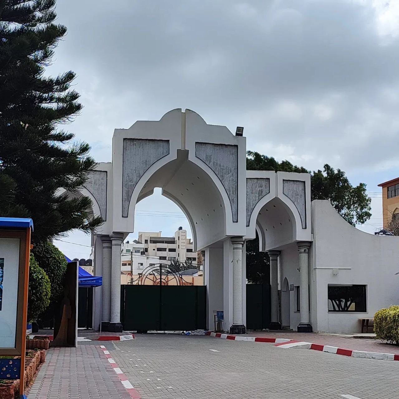 White arched entrance gate to university campus